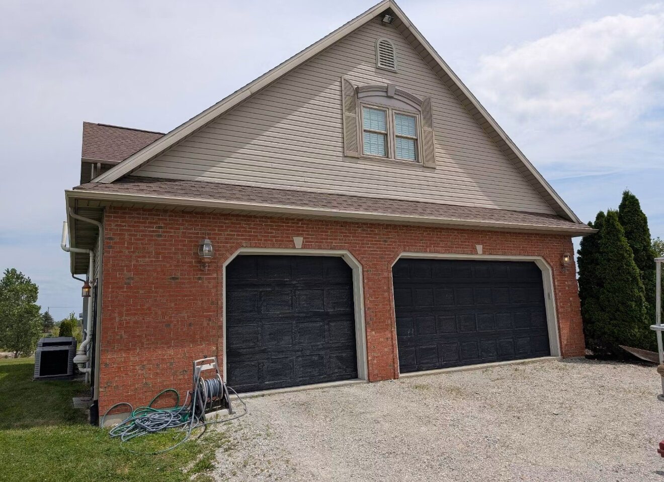 Seamless gutters installed on a brick garage
